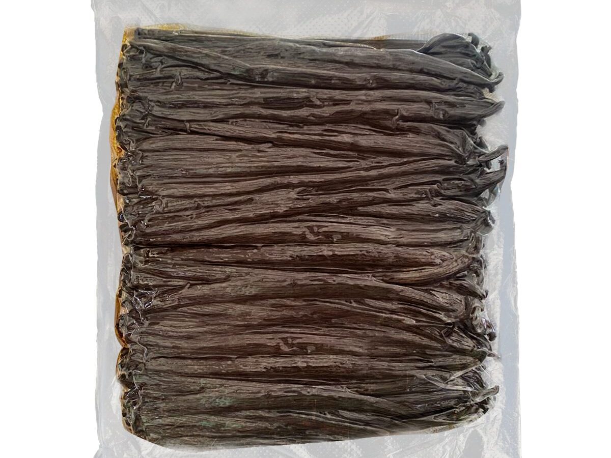 Whole cured vanilla beans vacuum-sealed in a clear pack, photographed flat on white